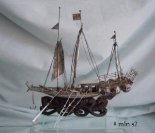 The silver ship 6-1/4" long x 4-1/2 tall
