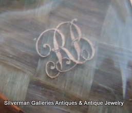 Gold monogram letters beneath the heart shape glass