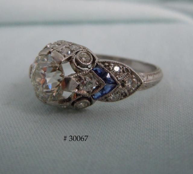 Center diamond is held in two double prongs and two single prongs