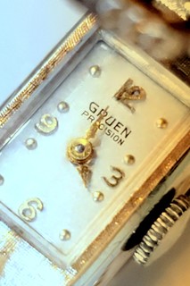 Watch face revealed under hinged buckle