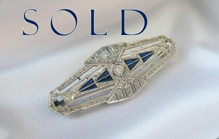 Art Deco Brooch of 91 Diamonds and 8 calibre-cut triangular blue flame fusion sapphires