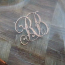 Detail :  Gold cut-out letters beneath glass