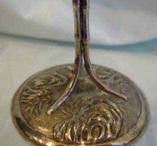 Bamboo stems terminate in repousse foot