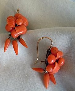 Three amphora-shape coral drops dangle from each earring pin with longest in center