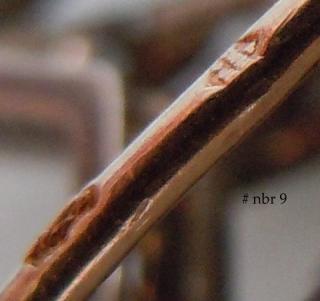 Pin stem with maker mark above semi-legible hallmark