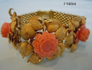 3 carved coral roses nest in remarkably realistic gold leaves