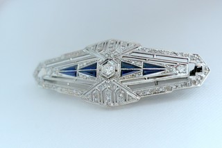 Art Deco Brooch of 91 Diamonds and 8 calibre-cut triangular blue flame fusion sapphires