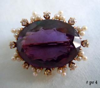 American (signed) Edwardian brooch centers a  vivd brilliant amethyst approximately 35 carats